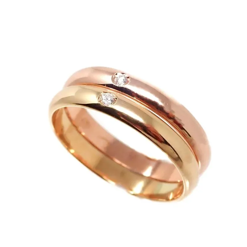 Alianza oro bicolor 18k dos brillantes 0.032ct. Diámetro 2mm. Ancho 3