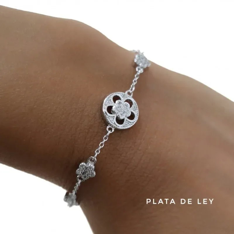 Pulsera plata Ley 925m rodiada 17cm. flores circonitas cierre reasa