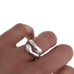 Sortija plata Ley 925m 4mm. forma abrazo manos cruzadas lisa abierta