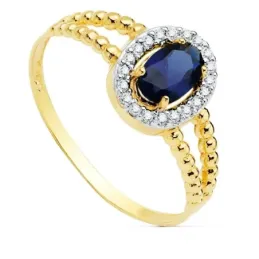 Sortija oro bicolor 18k mujer centro piedra azul 6x4mm. cerco circonitas laterales bandas
